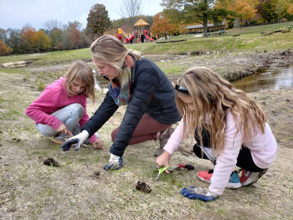 Lee Elementary students planting with Plaster Creek Stewards